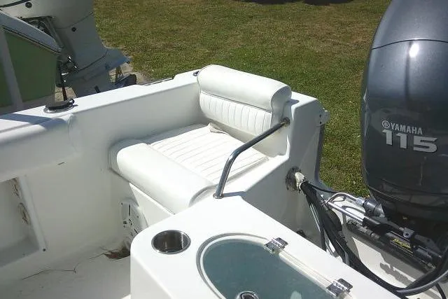 Slide: The Image of 2010 Sea Hunt Triton 202 boat interior with Yamaha 115 engine, featuring white seating. - 24