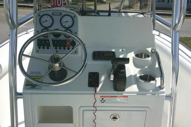 Slide: The Image of 2010 Sea Hunt Triton 202 boat dashboard with steering wheel and controls. - 26