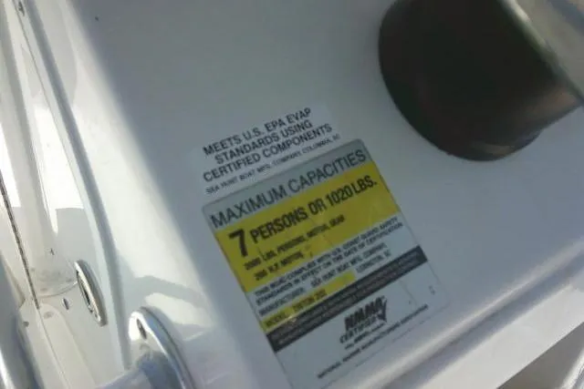 Slide: The Image of 2010 Sea Hunt Triton 202 capacity label, maximum 7 persons or 1020 lbs. - 27