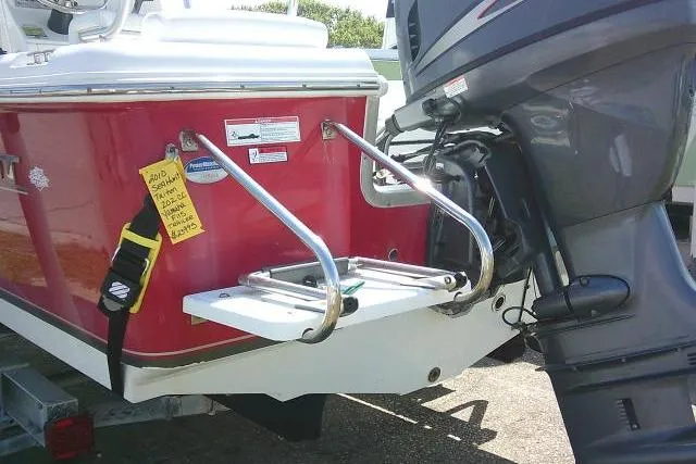 Slide: The Image of 2010 Sea Hunt Triton 202 boat with outboard motor and swim ladder. - 3
