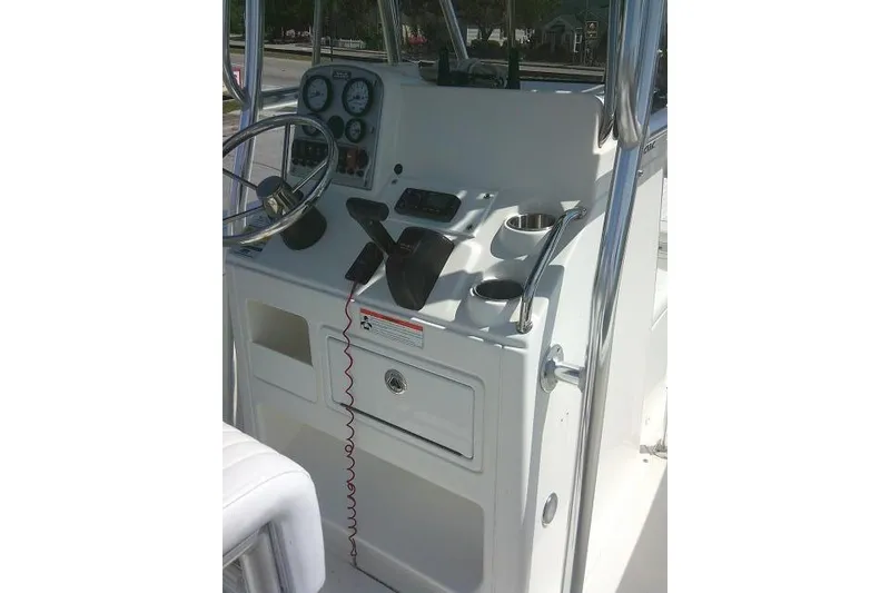 Slide: The Image of 2010 Sea Hunt Triton 202 boat console with steering wheel and gauges. - 31