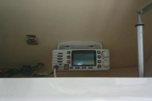 Slide: The Image of Marine radio installed on a 2010 Sea Hunt Triton 202 boat dashboard. - 33