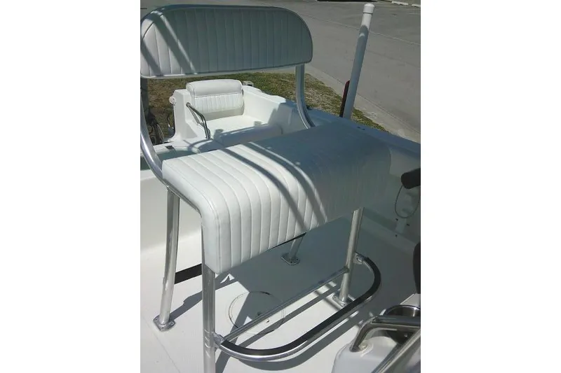Slide: The Image of White seating on a 2010 Sea Hunt Triton 202 boat, featuring sleek metal frames. - 34