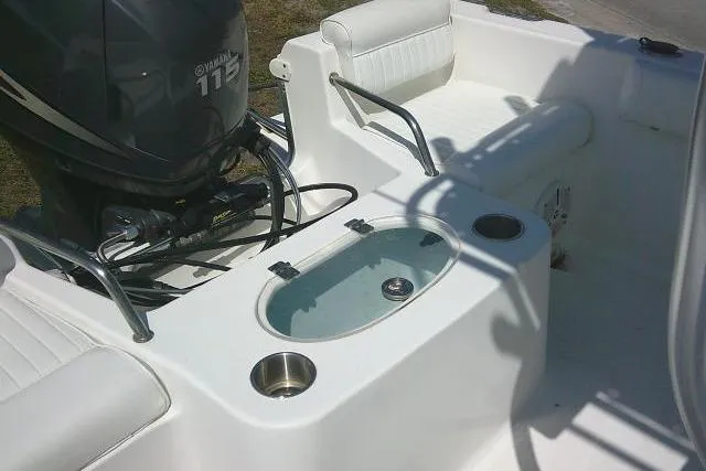 Slide: The Image of 2010 Sea Hunt Triton 202 boat interior with Yamaha 115 engine and seating. - 37