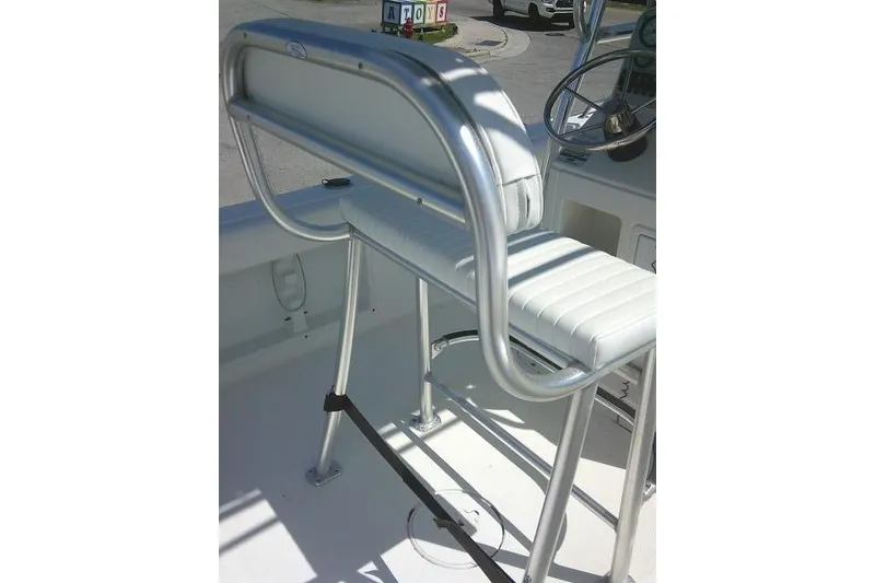 Slide: The Image of 2010 Sea Hunt Triton 202 boat seat with stainless steel frame and white cushion. - 38