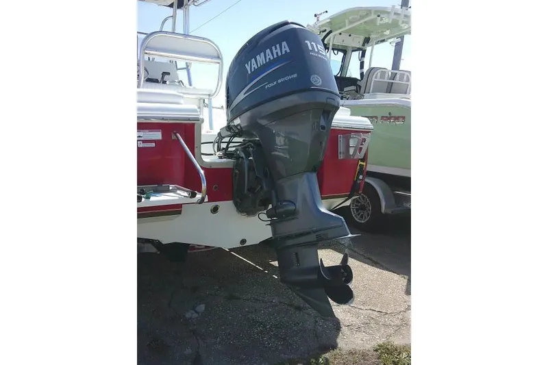 Slide: The Image of 2010 Sea Hunt Triton 202 with Yamaha 115 outboard motor, parked on a trailer. - 4