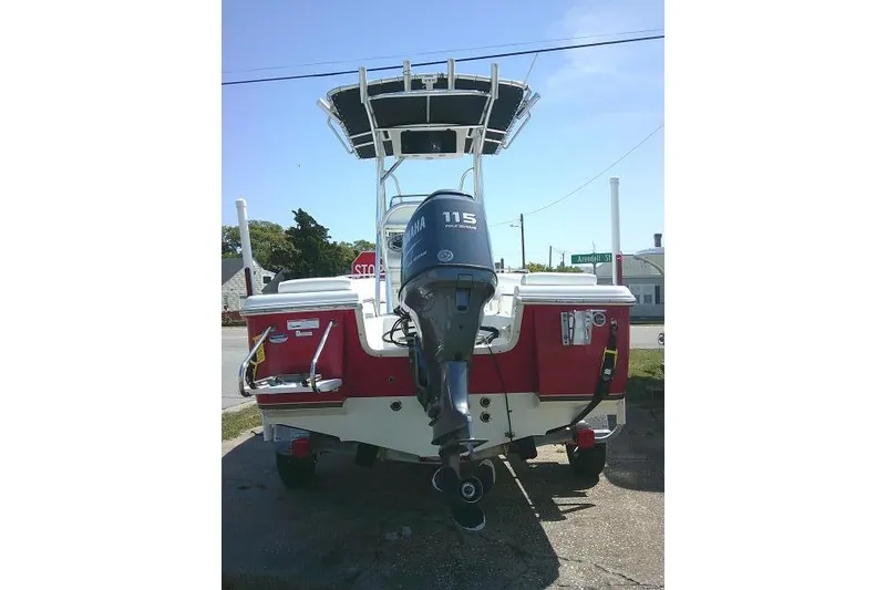 Slide: The Image of 2010 Sea Hunt Triton 202 boat with Yamaha 115 outboard motor, parked outdoors. - 5