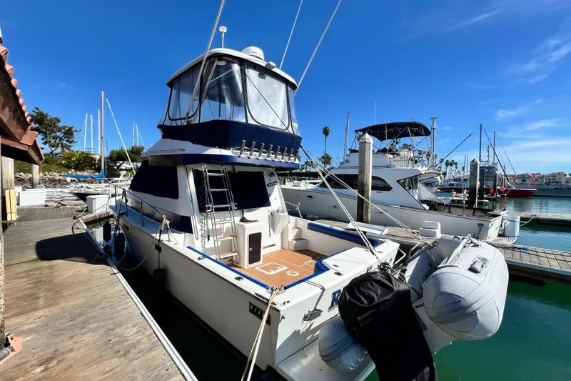 Slide: The Image of 1990 Mediterranean 38 Sport Fisher docked at marina under clear blue sky. - 10