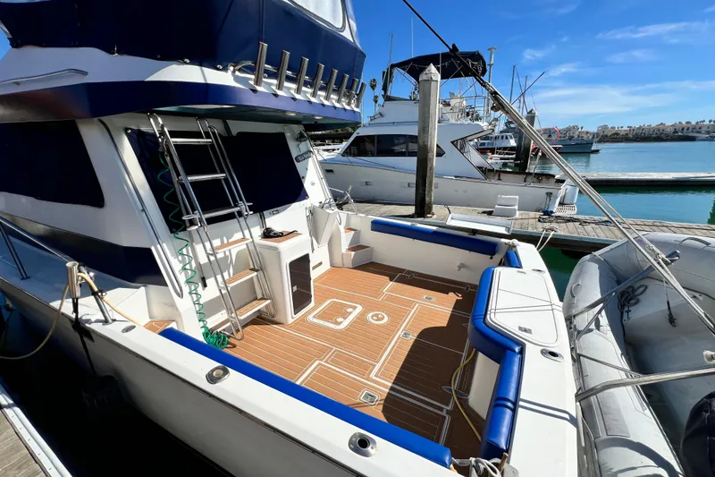 Slide: The Image of 1990 Mediterranean 38 Sport Fisher yacht docked at marina under clear blue sky. - 11