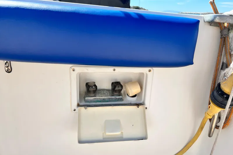 Slide: The Image of 1990 Mediterranean 38 Sport Fisher boat detail with blue cushion and utility panel. - 12