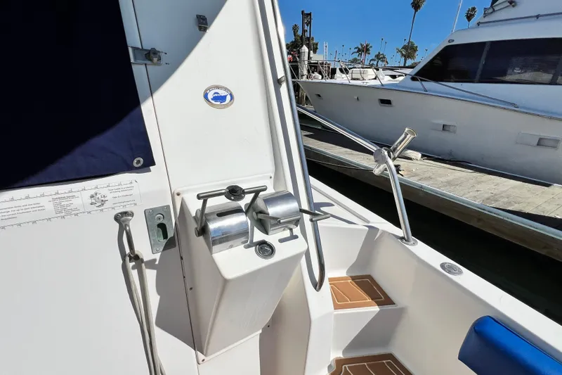 Slide: The Image of 1990 Mediterranean 38 Sport Fisher boat docked, featuring control panel and deck details. - 15