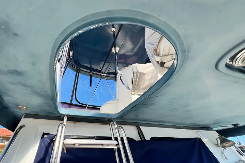 Slide: The Image of 1990 Mediterranean 38 Sport Fisher boat interior with ladder and open hatch view. - 20