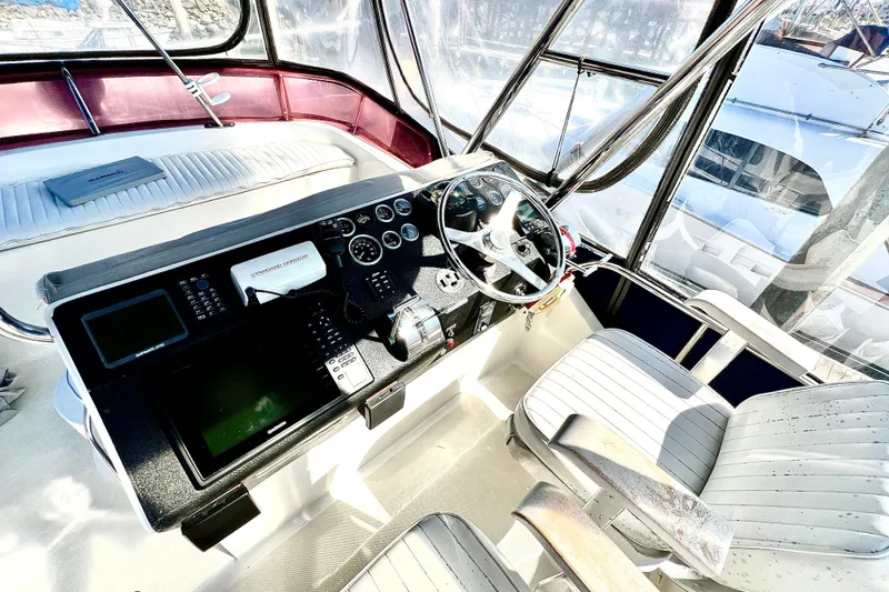 Slide: The Image of Cockpit of 1990 Mediterranean 38 Sport Fisher with steering wheel and navigation equipment. - 23