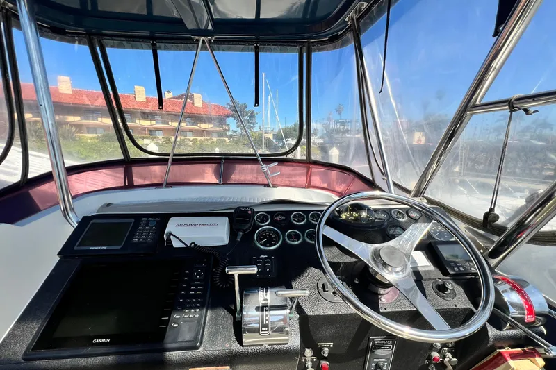 Slide: The Image of Cockpit view of a 1990 Mediterranean 38 Sport Fisher boat with navigation equipment. - 24