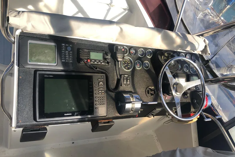 Slide: The Image of Control panel of a 1990 Mediterranean 38 Sport Fisher boat with navigation equipment. - 25