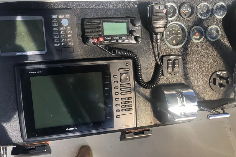 Slide: The Image of Control panel of a 1990 Mediterranean 38 Sport Fisher with navigation and communication equipment. - 26