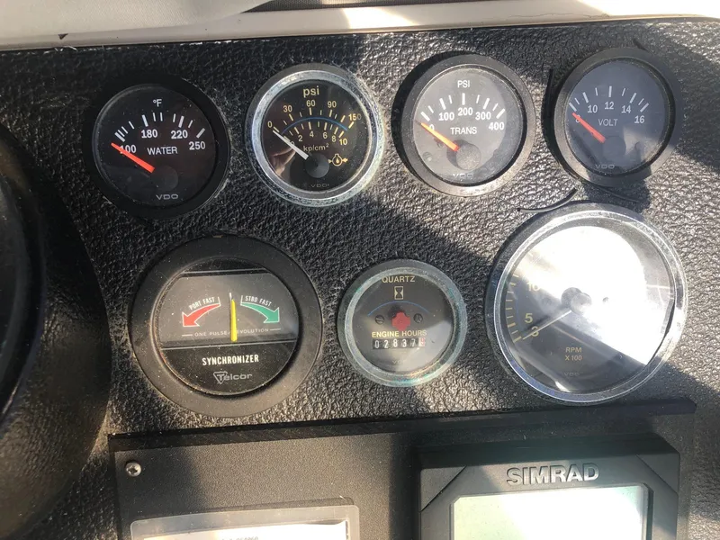 Slide: The Image of Dashboard of a 1990 Mediterranean 38 Sport Fisher with various gauges and a Simrad display. - 28