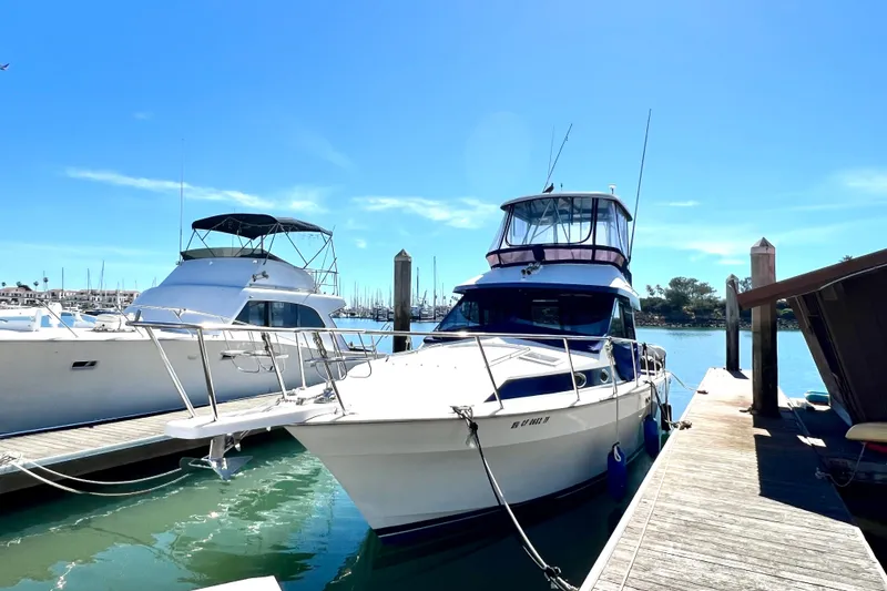 Slide: The Image of 1990 Mediterranean 38 Sport Fisher docked at marina under clear blue sky. - 3