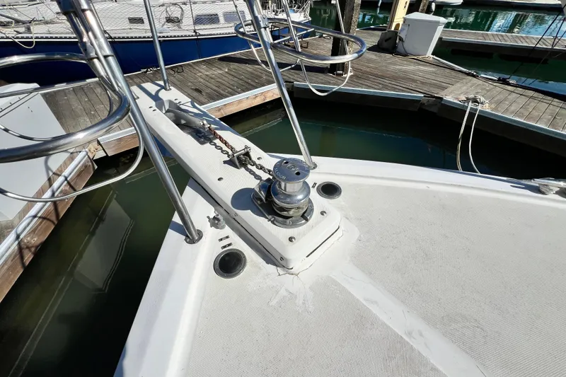 Slide: The Image of Bow of 1990 Mediterranean 38 Sport Fisher at dock, featuring anchor winch. - 31