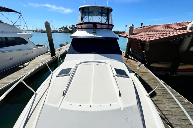 Slide: The Image of 1990 Mediterranean 38 Sport Fisher docked at marina under clear blue sky. - 32