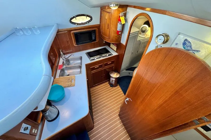 Slide: The Image of Interior of 1990 Mediterranean 38 Sport Fisher boat with kitchenette and wooden cabinetry. - 36