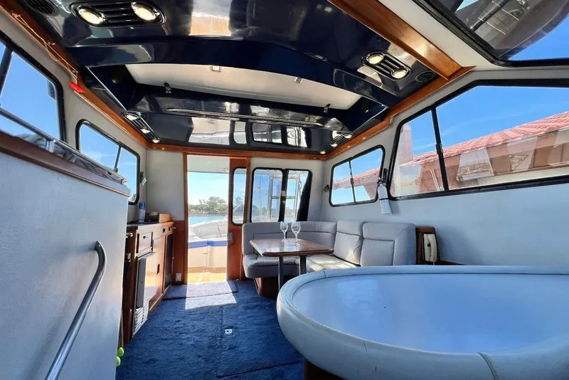 Slide: The Image of Interior of 1990 Mediterranean 38 Sport Fisher yacht with modern seating and table. - 37