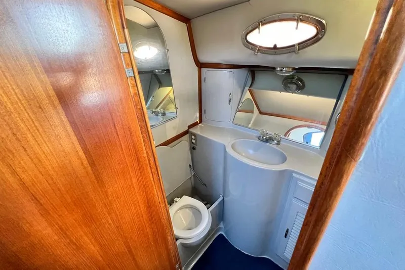 Slide: The Image of 1990 Mediterranean 38 Sport Fisher yacht bathroom with wooden accents and compact design. - 40