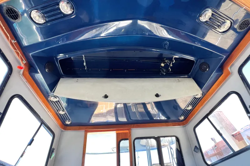 Slide: The Image of Interior view of a 1990 Mediterranean 38 Sport Fisher boat with blue ceiling. - 46