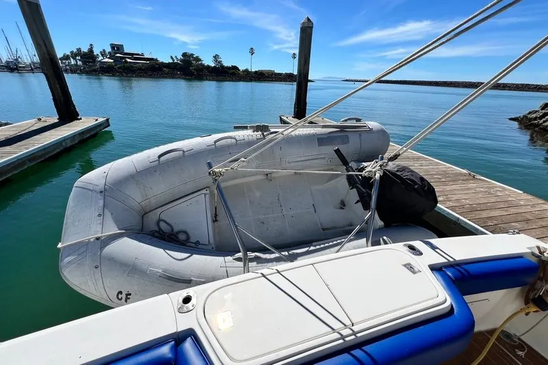 Slide: The Image of Inflatable boat docked beside 1990 Mediterranean 38 Sport Fisher on a sunny day. - 47