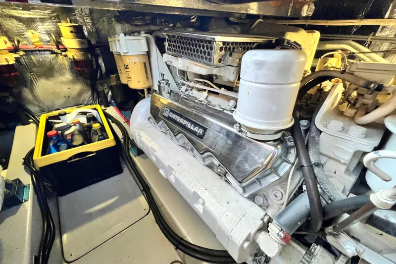Slide: The Image of Engine room of 1990 Mediterranean 38 Sport Fisher with Caterpillar engine and maintenance supplies. - 52