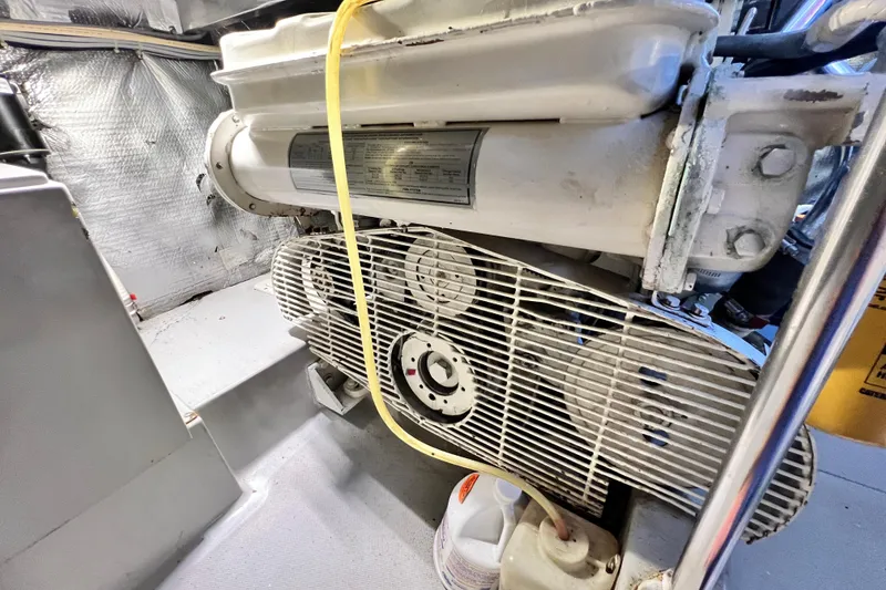 Slide: The Image of Engine room of 1990 Mediterranean 38 Sport Fisher boat, showcasing mechanical components. - 54