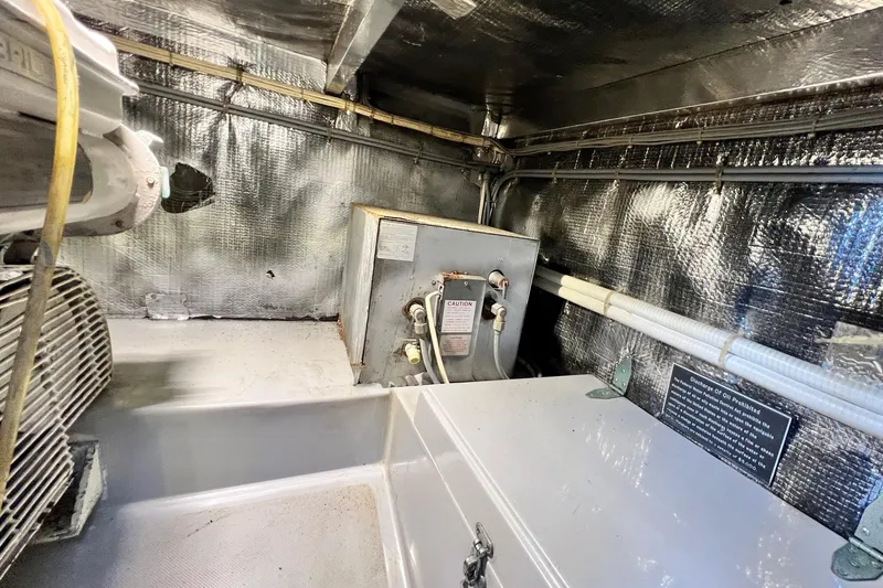 Slide: The Image of Engine room of 1990 Mediterranean 38 Sport Fisher boat with metallic insulation. - 56