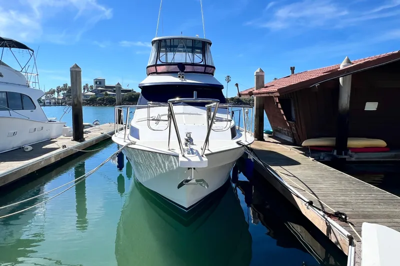 Slide: The Image of 1990 Mediterranean 38 Sport Fisher yacht docked at marina under clear blue sky. - 7