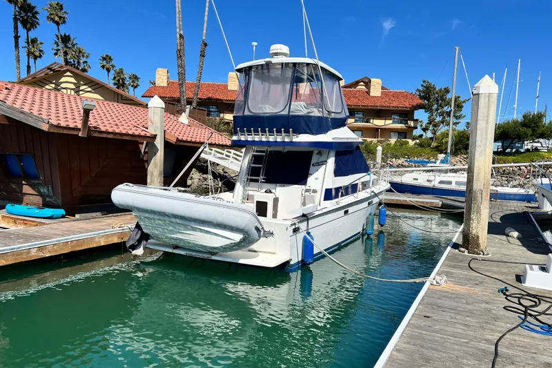 Slide: The Image of 1990 Mediterranean 38 Sport Fisher docked at marina with clear blue sky. - 8
