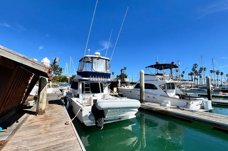 Slide: The Image of 1990 Mediterranean 38 Sport Fisher docked at a sunny marina. - 9