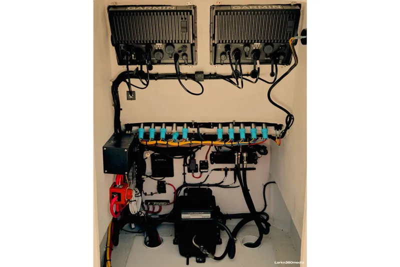 Slide: The Image of Clean electrical rigging in the 2025 LTB 25 Demo Boat with twin Garmin 8612s, and plenty of room for a Porta-potty head. - 4