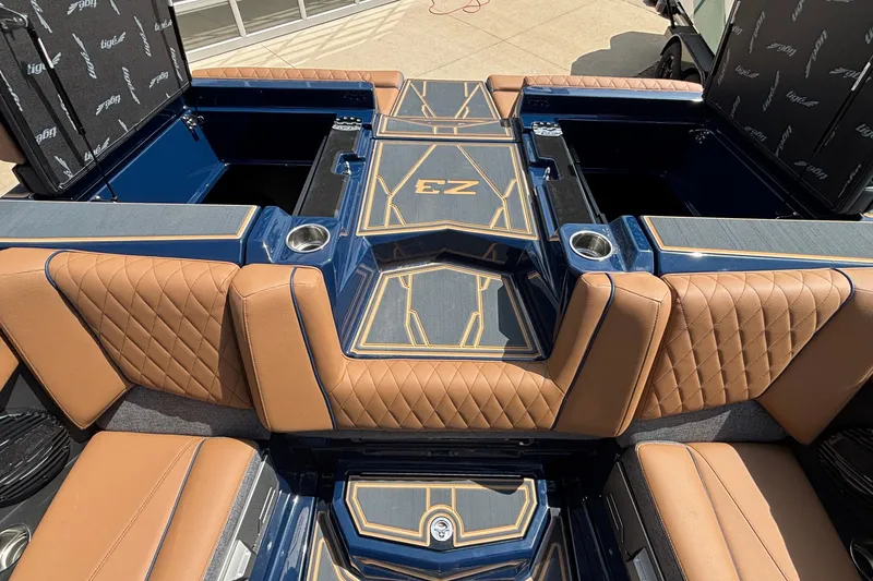 Slide: The Image of 2026 Tigé Z3 boat interior with tan quilted seats and blue accents. - 28