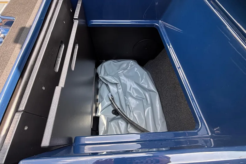 Slide: The Image of Storage compartment of 2026 Tigé Z3 boat with blue interior and equipment. - 29