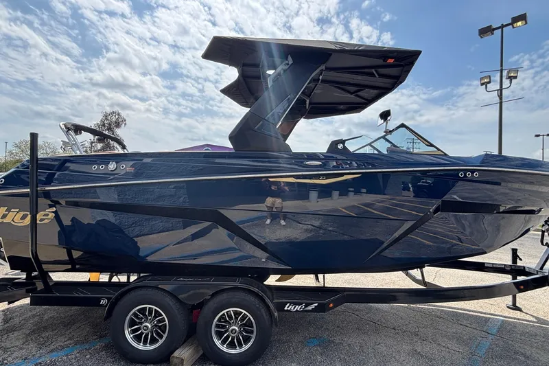 Slide: The Image of 2026 Tigé Z3 boat on trailer under a partly cloudy sky. - 3