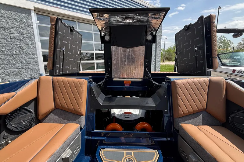 Slide: The Image of 2026 Tigé Z3 boat interior with tan quilted seats and open engine compartment. - 33