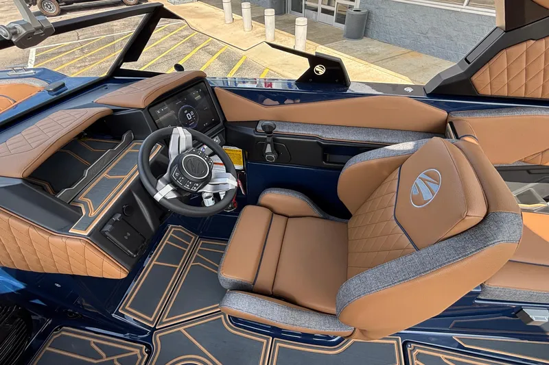Slide: The Image of 2026 Tigé Z3 boat interior with luxurious tan and blue seating, modern dashboard, and steering wheel. - 35