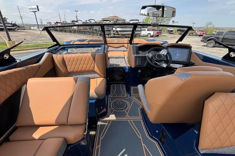 Slide: The Image of Luxurious interior of 2026 Tigé Z3 boat with tan leather seating and modern dashboard. - 38