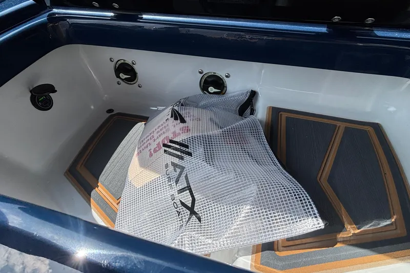 Slide: The Image of 2026 Tigé Z3 boat storage compartment with surfboard and padded flooring. - 41