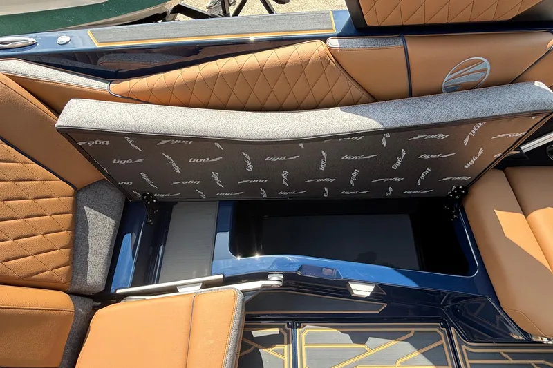 Slide: The Image of 2026 Tigé Z3 boat interior with tan and gray seating, showcasing storage compartment. - 45