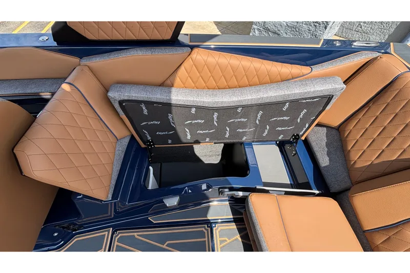 Slide: The Image of 2026 Tigé Z3 boat interior with tan diamond-stitched upholstery and storage compartment. - 46