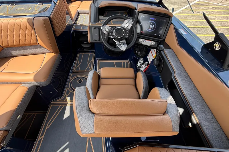 Slide: The Image of 2026 Tigé Z3 boat interior with luxurious tan and gray seating, modern dashboard, and steering wheel. - 47