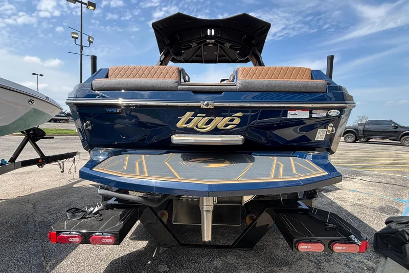 Slide: The Image of 2026 Tigé Z3 boat rear view in parking lot, showcasing sleek design and features. - 5