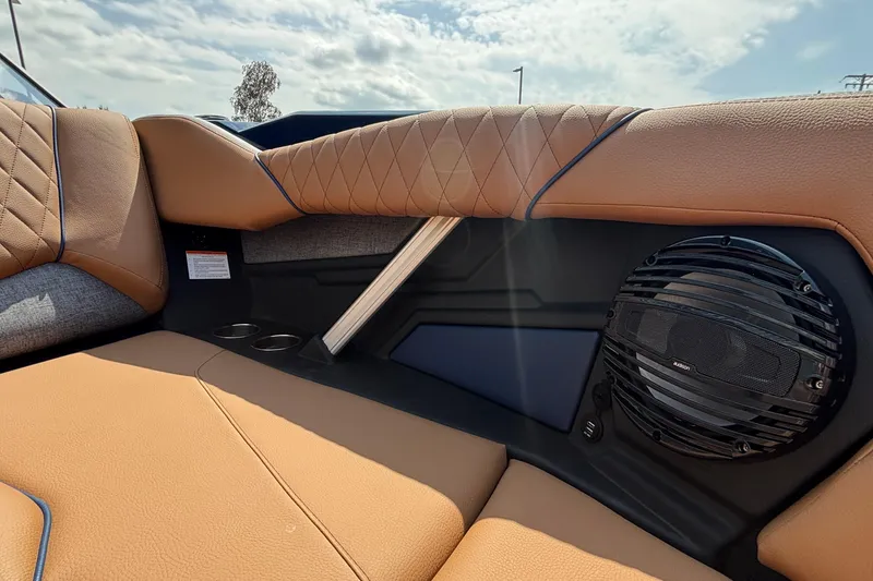 Slide: The Image of 2026 Tigé Z3 boat interior with tan upholstery, speaker, and cup holders. - 66