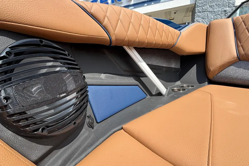 Slide: The Image of 2026 Tigé Z3 boat interior with tan upholstery, speaker, and cup holders. - 67