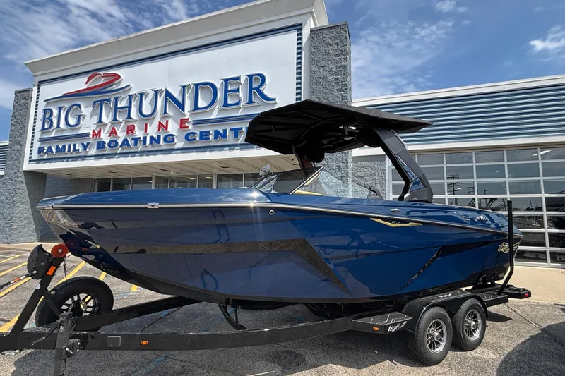Slide: The Image of 2026 Tigé Z3 boat at Big Thunder Marine dealership, blue exterior, parked on trailer. - 71